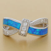 Round blue opal sterling silver ring with sparkling accents, showcasing elegance and luxury in jewelry design.